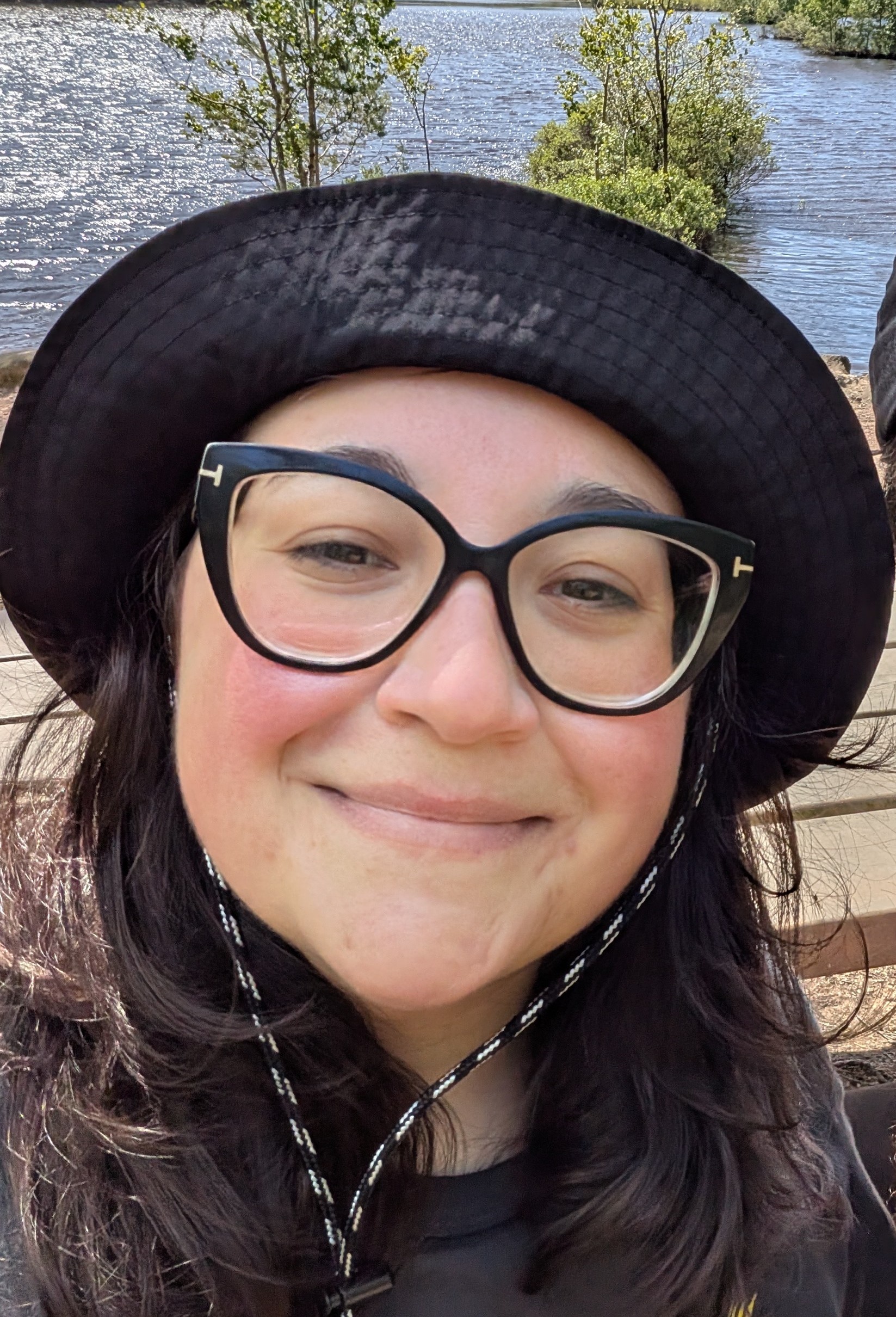 Photo of smiling Daniela wearing a buckethat